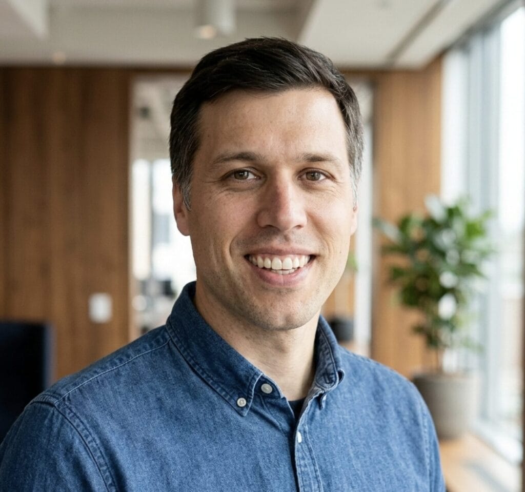 Freundliches Teammitglied bei Netzgold in modernem Büro, digitaler Experte.